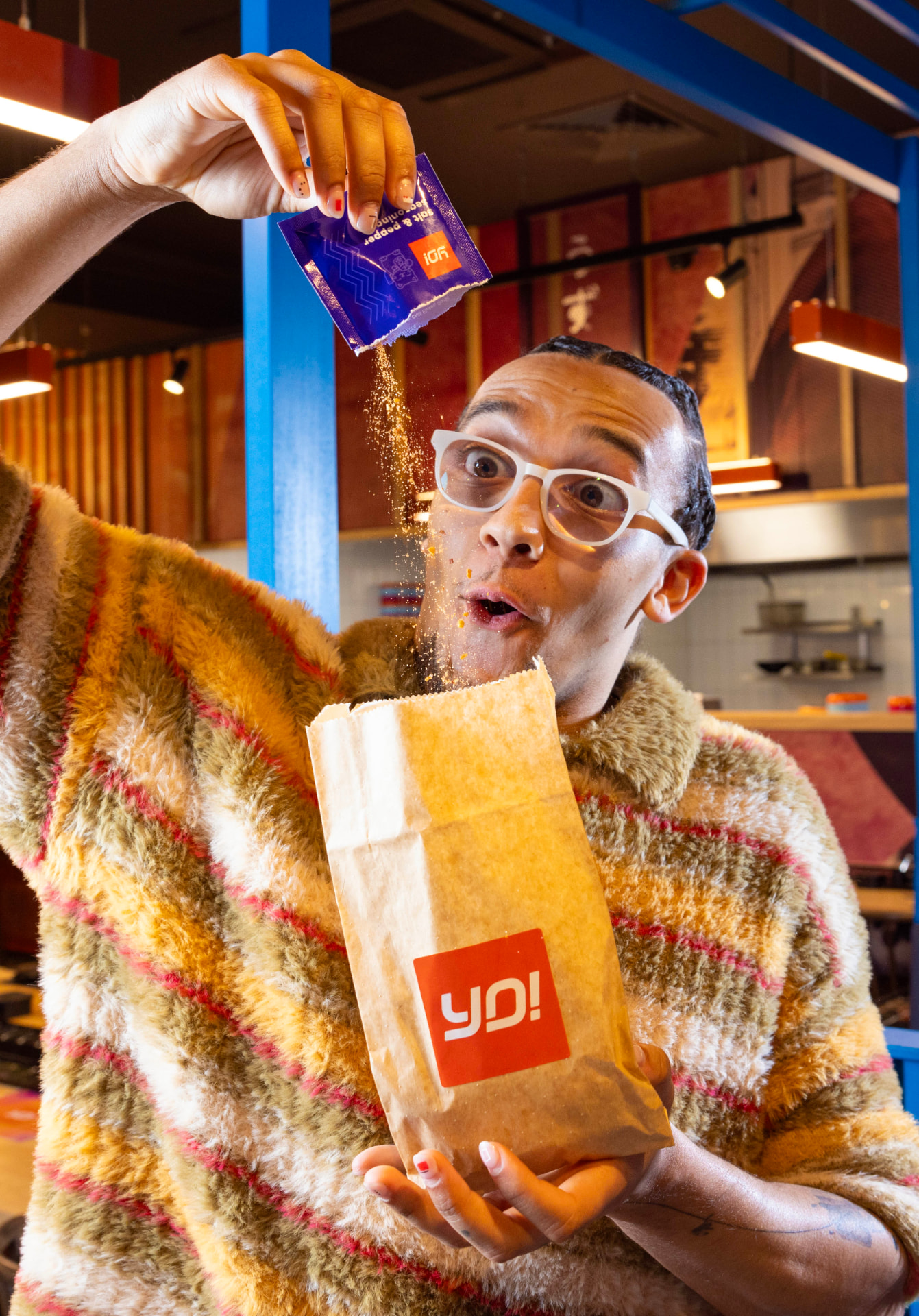 Perri Kiely pouring seasoning into a YO! Sushi Furi Furi bag