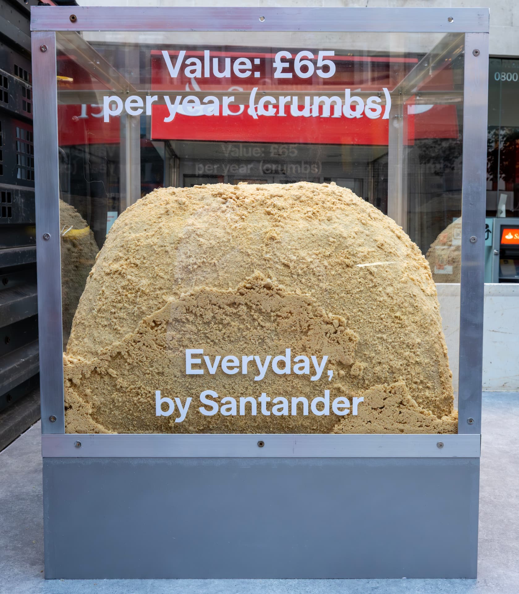 Display comparing Santander account value to biscuit crumbs